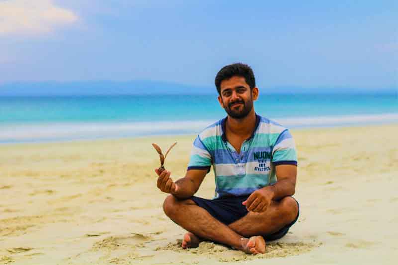 Anoop sititng at radhanagar beach havelock